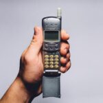 Vecchio Nokia 3310 su sfondo bianco, simbolo di nostalgia e valore collezionistico.